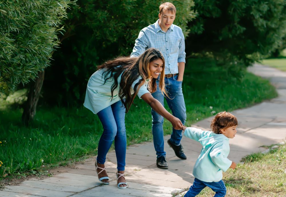 Young family walking in park