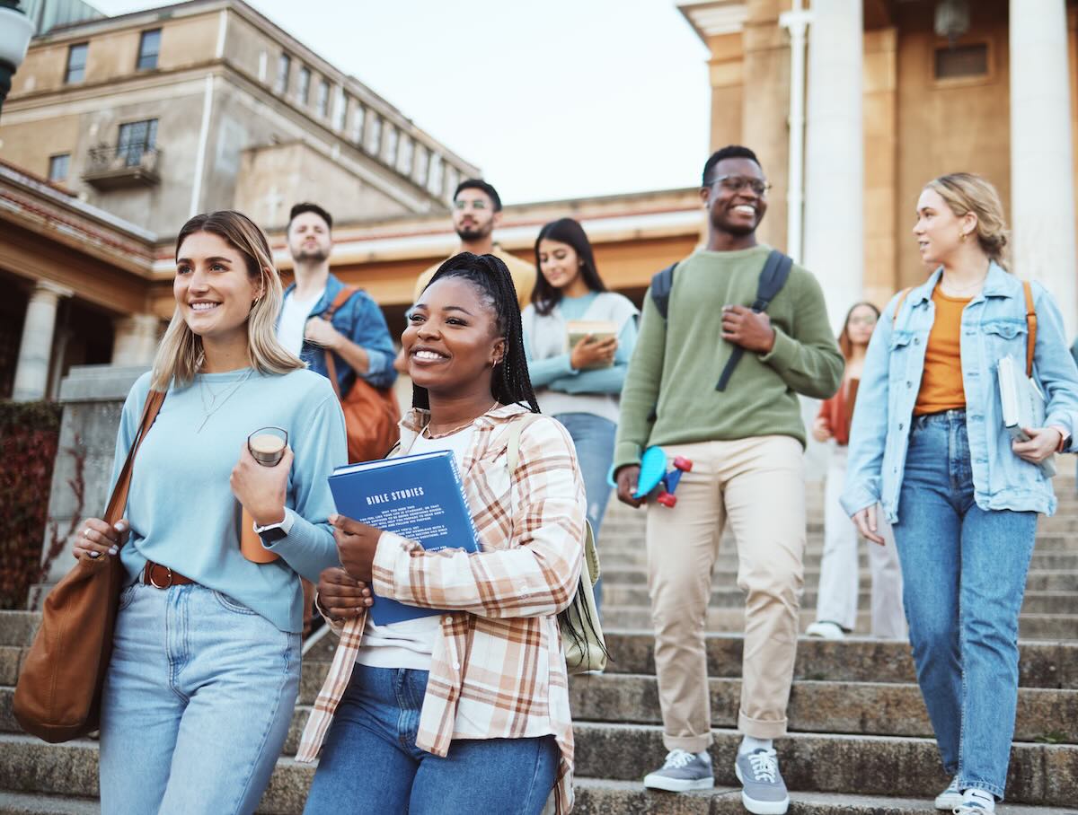 Students walking down the stairs in university campus 
